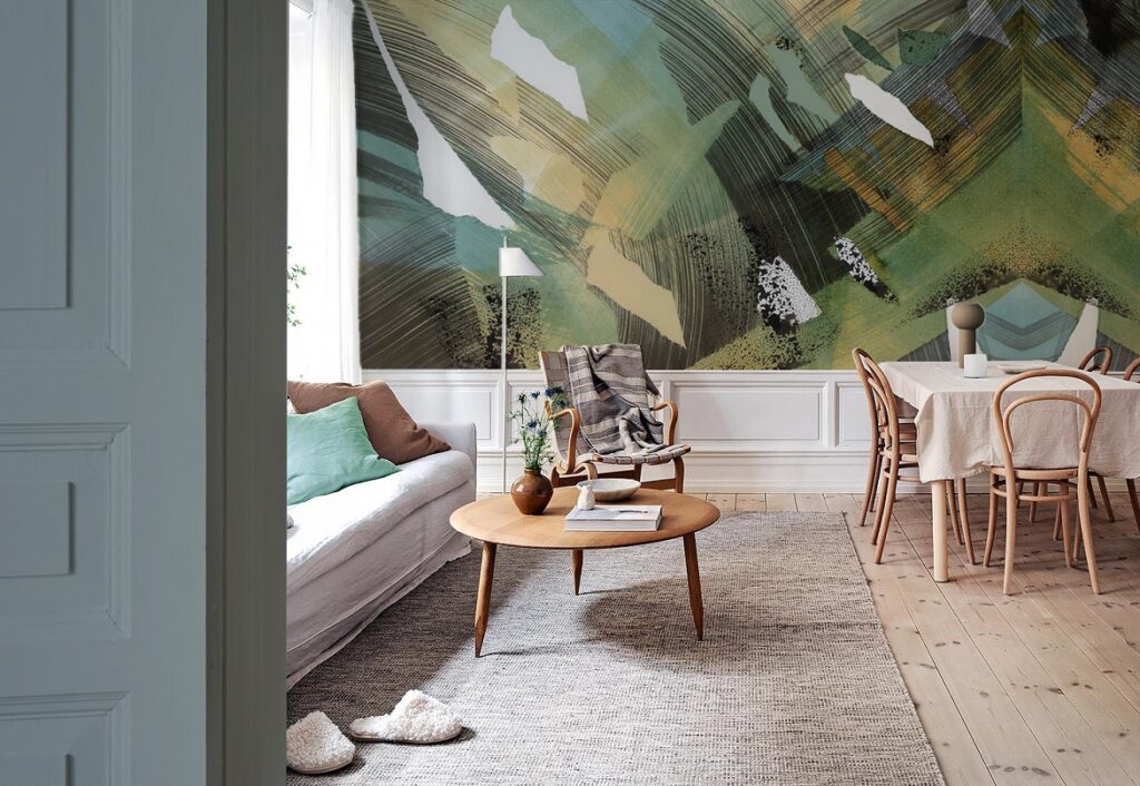 Stylish wallpapered wall of a Scandinavian home. Green mural wallpaper in a living room