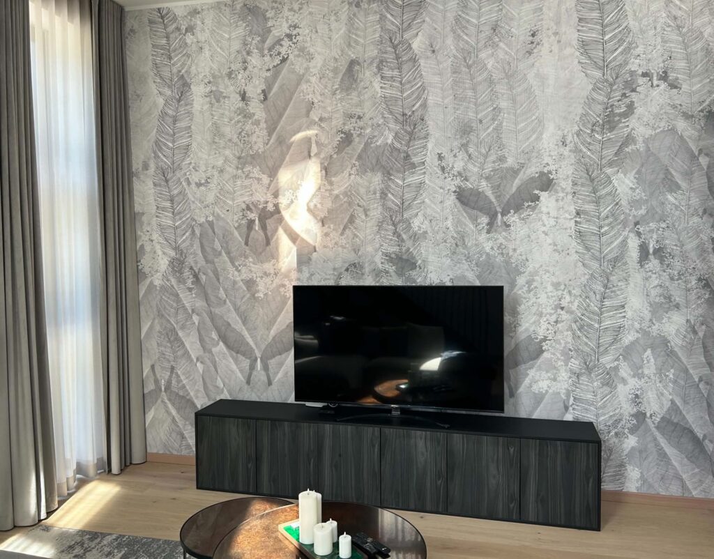 Grey mural wallpaper Deconstructed Feathers in a customer home living room feature wall. Baubauwall Wallpapers