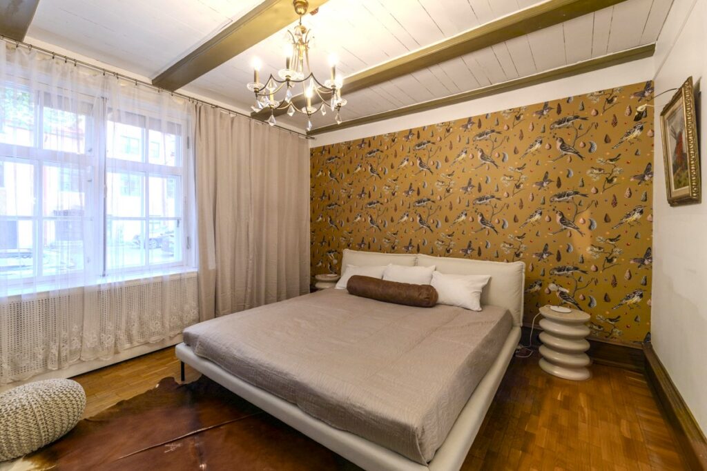 Bird pattern wallpaper in mustrd, set ona bedroom feature wall. Baubauwall Wallpapers